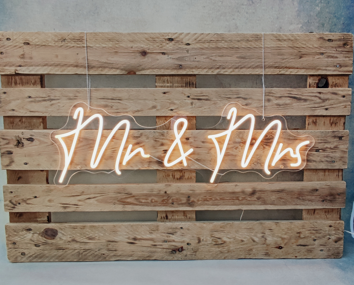 Mr & Mrs Neon Schild bei einer Boho-Hochzeit im Traubogen